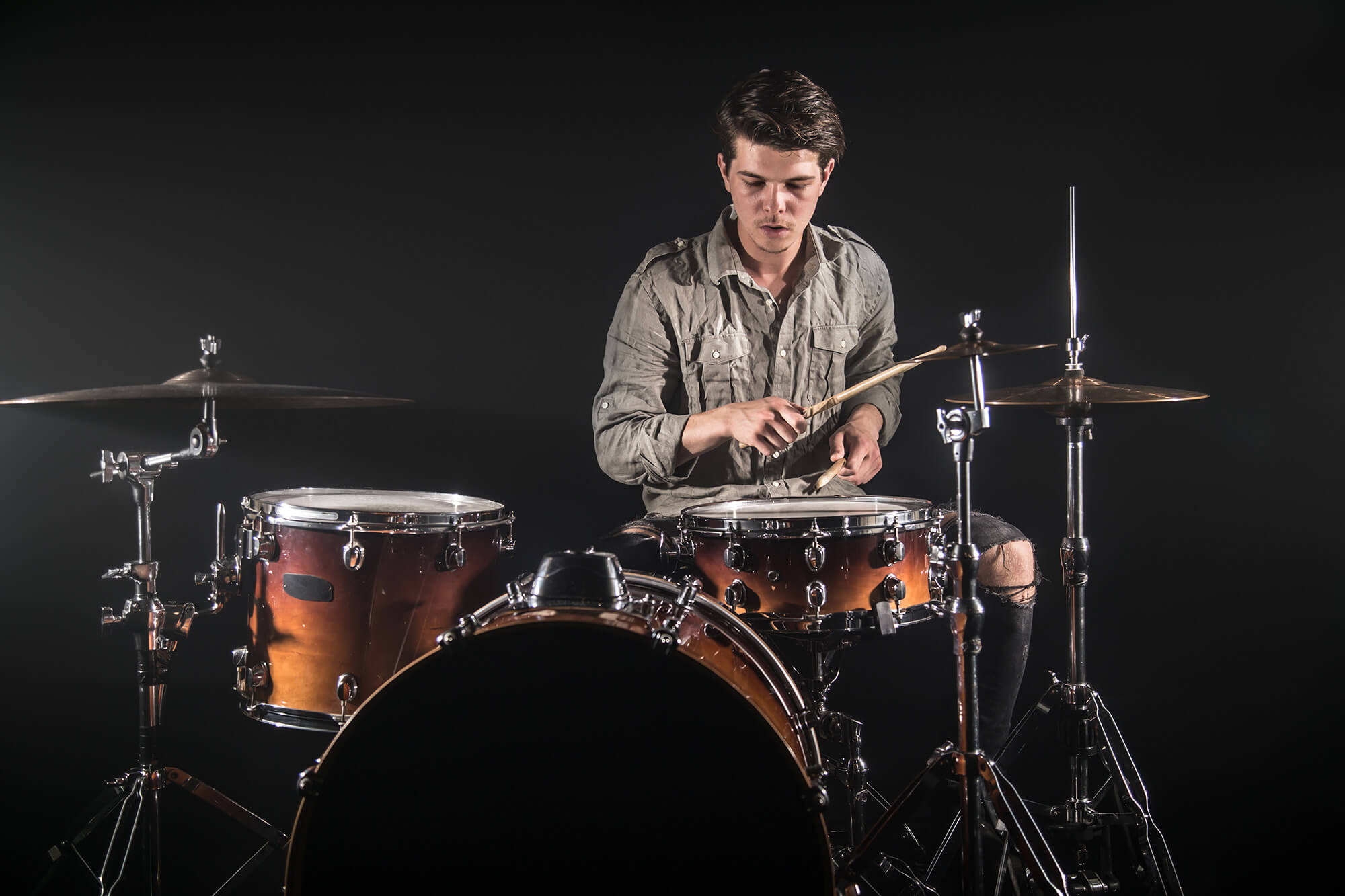 professional-drummer-playing-drum-set-stage-black-background-with-drum-sticks-vintage-look-top-view-smoke-effect